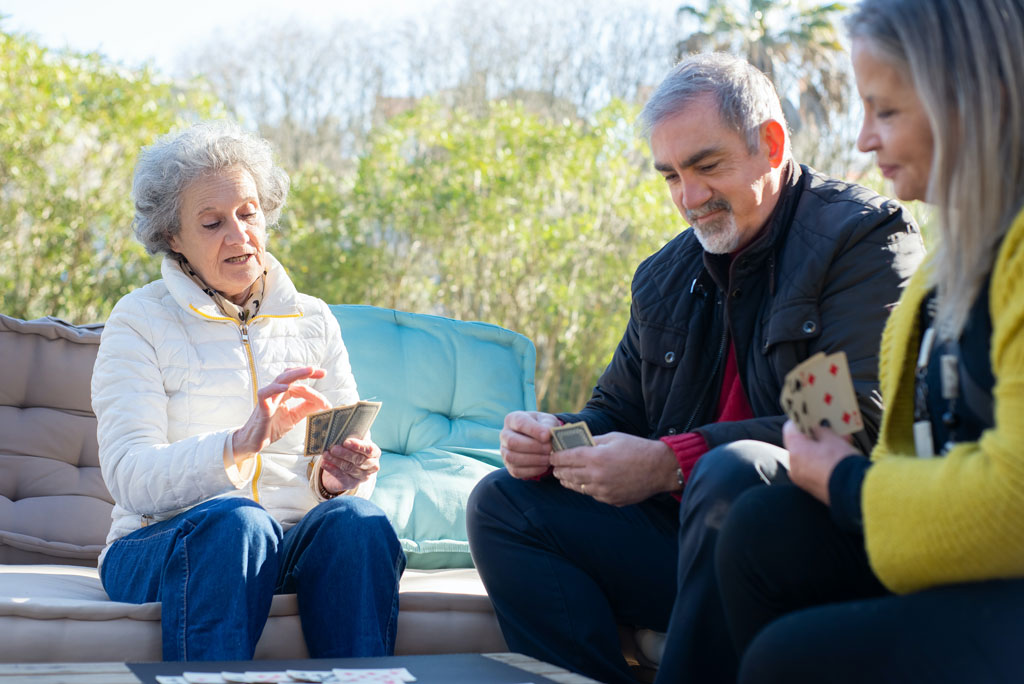 Group of older adults playing a card game