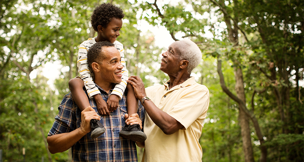 Grandfather with son and grandson, spending time together outdoors